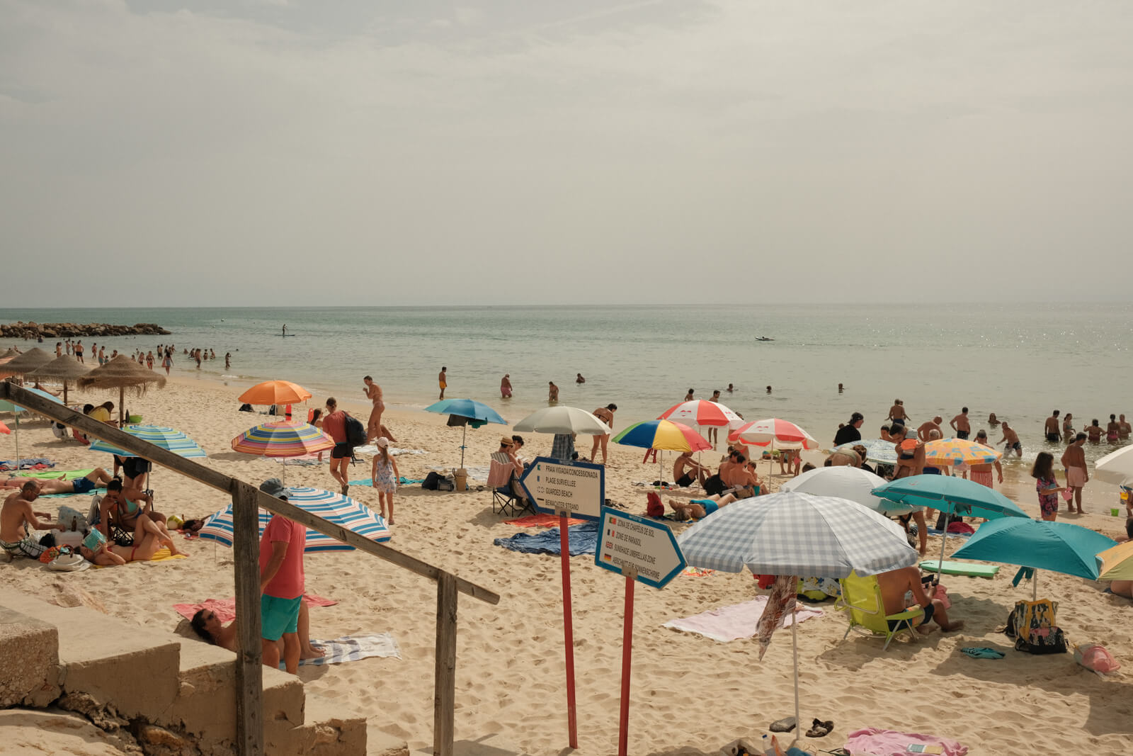 Busy summer beach day in Ilha do Farol Algarve, Portugal